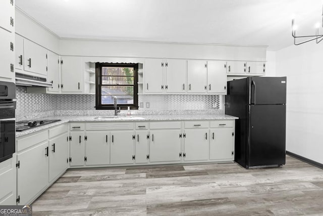 kitchen featuring white cabinetry, sink, light hardwood / wood-style flooring, and black appliances