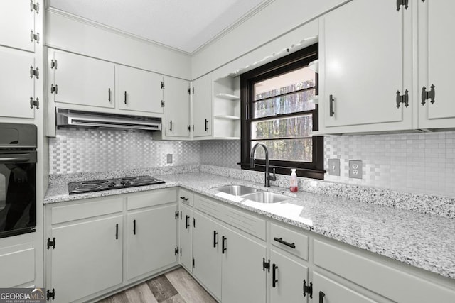 kitchen with sink, white cabinets, black appliances, and tasteful backsplash