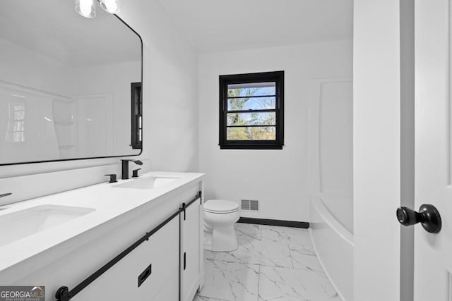 bathroom featuring toilet and vanity