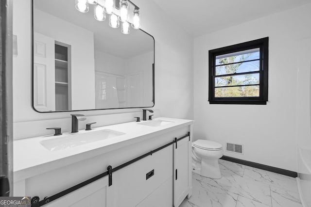 bathroom with toilet and vanity