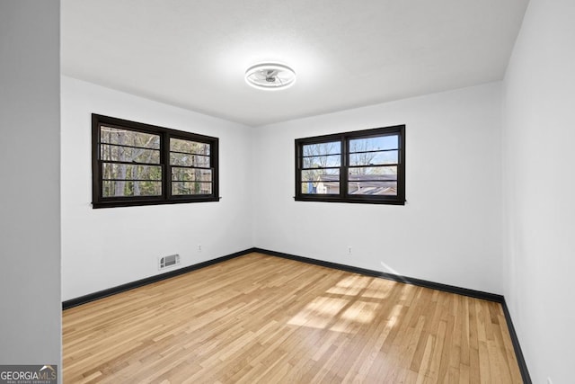 spare room featuring light wood-type flooring