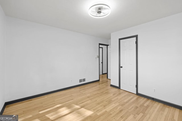 spare room featuring light hardwood / wood-style floors