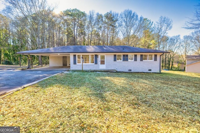 ranch-style home with a carport and a front yard