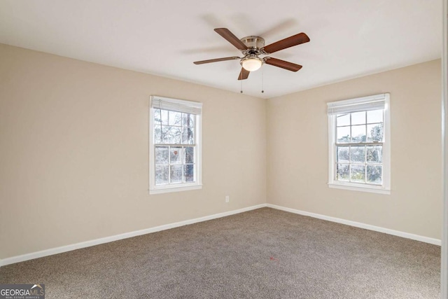 carpeted spare room with ceiling fan and a healthy amount of sunlight