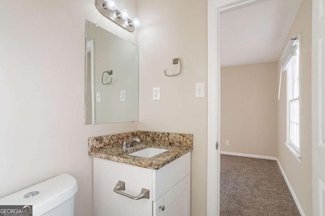 bathroom featuring toilet and vanity