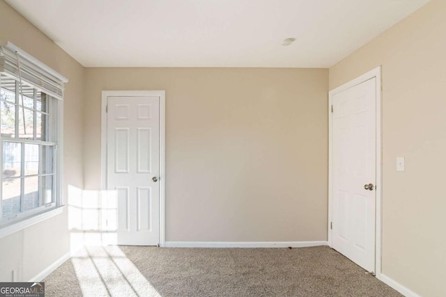 carpeted empty room featuring plenty of natural light