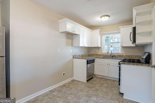 kitchen with white cabinets, sink, dark stone countertops, and stainless steel appliances