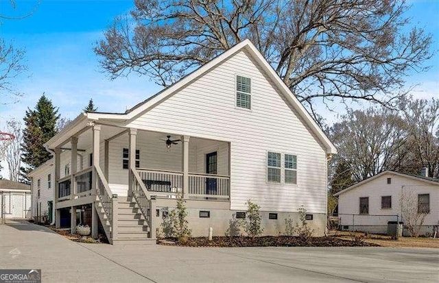 view of property exterior featuring covered porch and ceiling fan