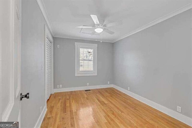 unfurnished room with light wood-type flooring, ceiling fan, and ornamental molding