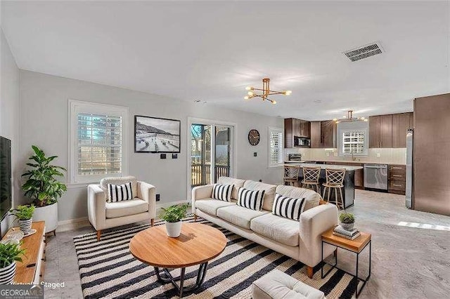 living room featuring a notable chandelier