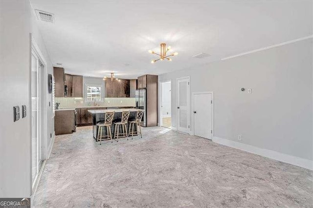 unfurnished living room with a chandelier