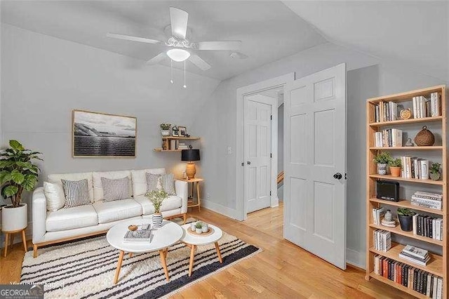 living room with ceiling fan and light wood-type flooring