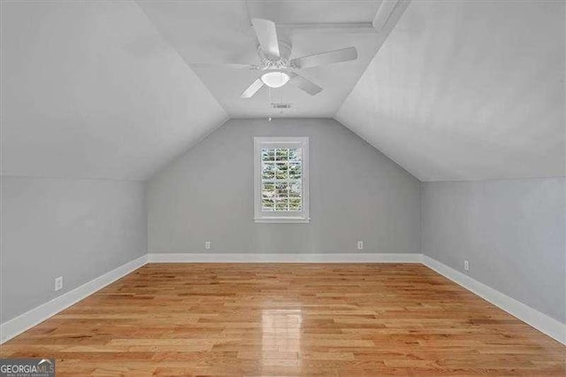 additional living space featuring light wood-type flooring, ceiling fan, and lofted ceiling