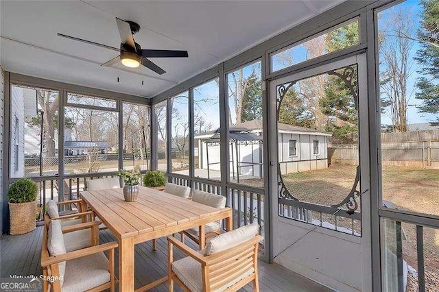 sunroom with ceiling fan and a healthy amount of sunlight