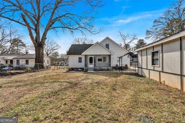 back of property featuring a porch and a lawn