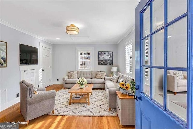 living room featuring ornamental molding and wood-type flooring