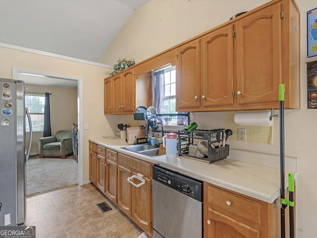 kitchen with light colored carpet, vaulted ceiling, sink, and stainless steel appliances