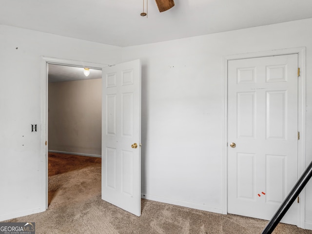 unfurnished bedroom with ceiling fan and carpet flooring