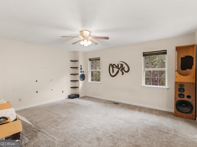 interior space featuring ceiling fan and carpet