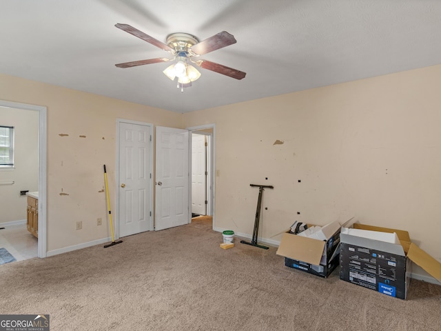 misc room with ceiling fan and light carpet