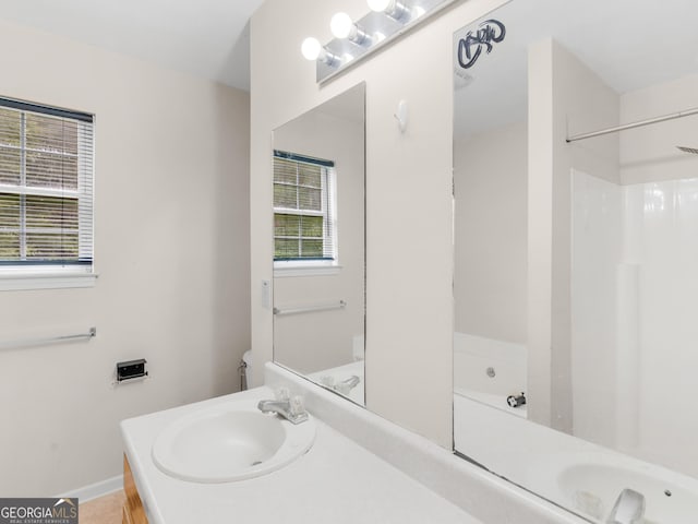 bathroom with a bath and vanity