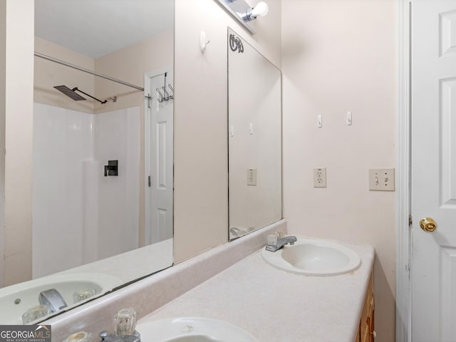 bathroom with walk in shower and vanity