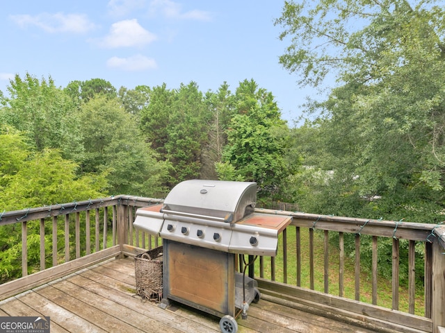 wooden deck with a grill