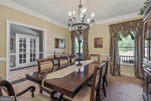 dining area featuring light carpet, french doors, an inviting chandelier, and ornamental molding