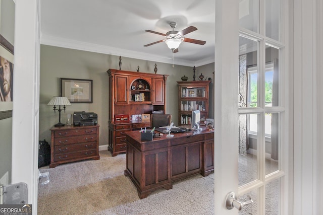 carpeted office space with ceiling fan, ornamental molding, and french doors