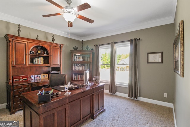 carpeted home office featuring ceiling fan and crown molding