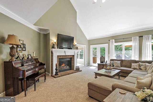 carpeted living room featuring high vaulted ceiling, french doors, a fireplace, and ceiling fan