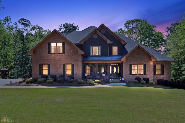 view of front of house featuring a lawn and a porch