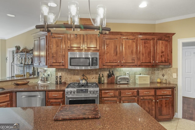 kitchen with backsplash, pendant lighting, crown molding, stainless steel appliances, and light tile patterned floors