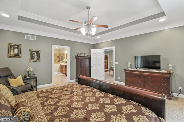 bedroom with ceiling fan, ornamental molding, and a tray ceiling