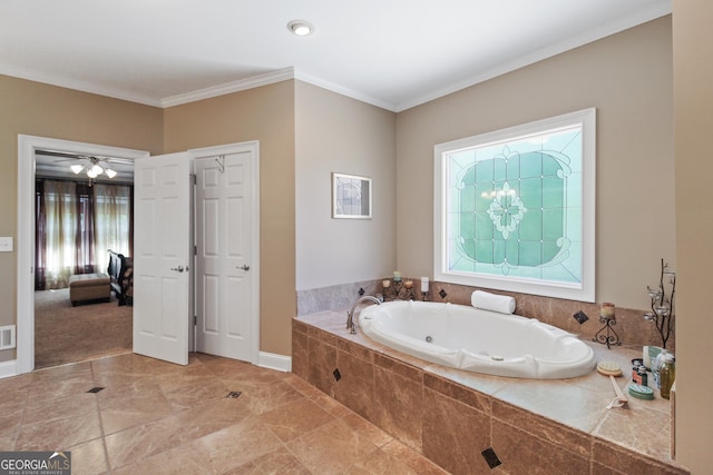 bathroom with a relaxing tiled tub and ornamental molding