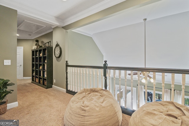 sitting room featuring light carpet, crown molding, and vaulted ceiling