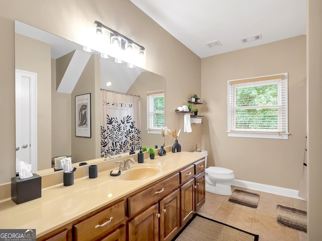 bathroom featuring toilet, tile patterned flooring, and vanity