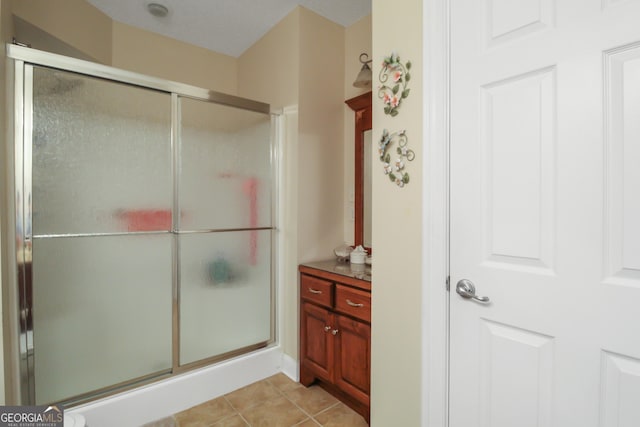 bathroom with walk in shower and tile patterned floors