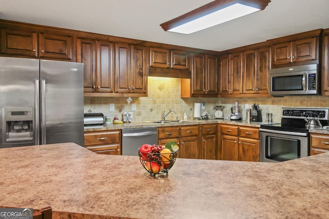 kitchen with stainless steel appliances, backsplash, and sink