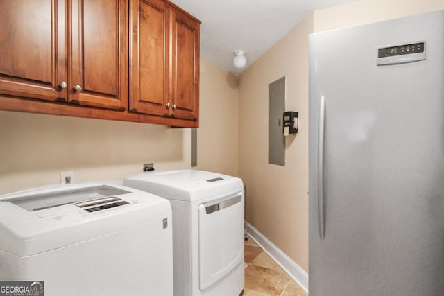 washroom featuring cabinets, light tile patterned floors, and washing machine and dryer