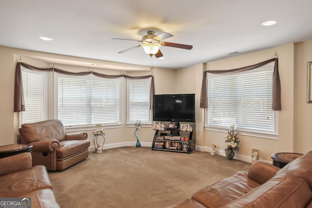 carpeted living room featuring ceiling fan