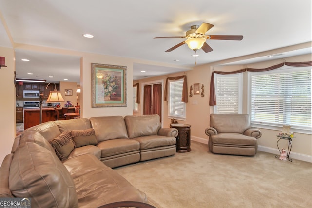 living room featuring ceiling fan and light colored carpet