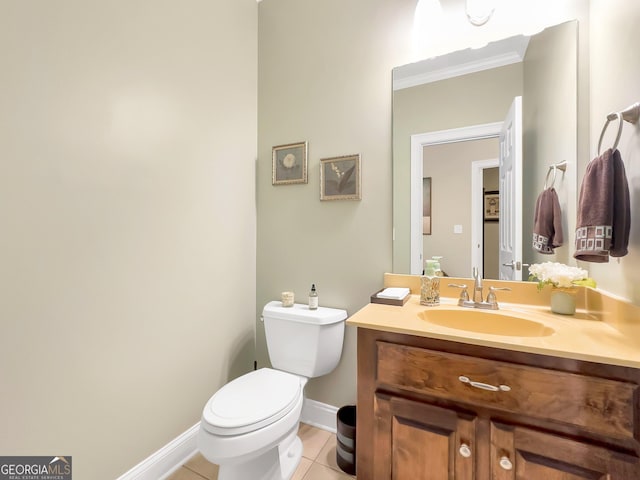 bathroom with toilet, ornamental molding, tile patterned floors, and vanity