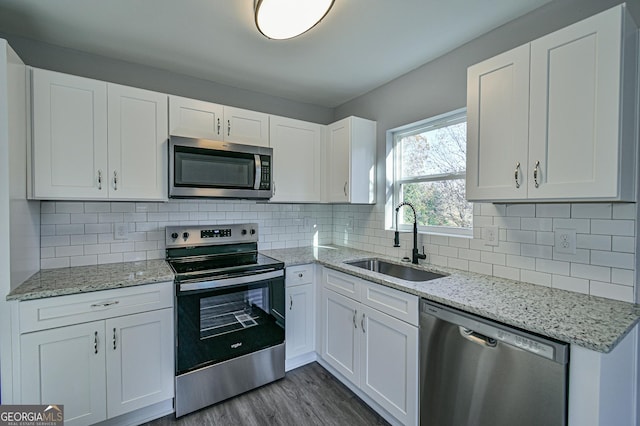 kitchen with sink, white cabinets, and appliances with stainless steel finishes