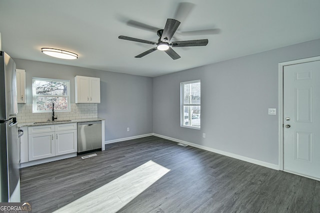 kitchen with white cabinets, stainless steel appliances, sink, dark hardwood / wood-style floors, and ceiling fan