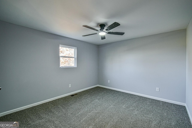 carpeted spare room featuring ceiling fan