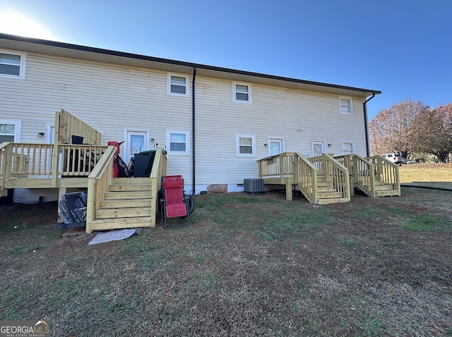 back of house featuring a wooden deck and central AC unit