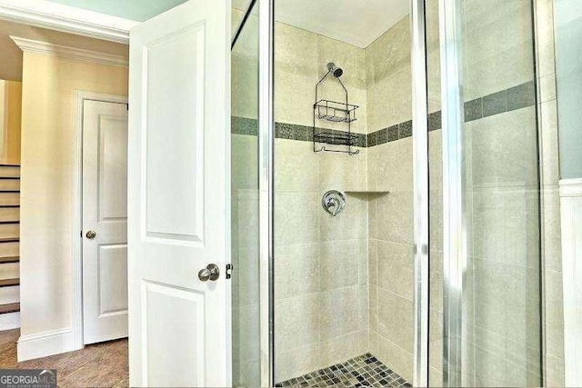 bathroom with a shower with door