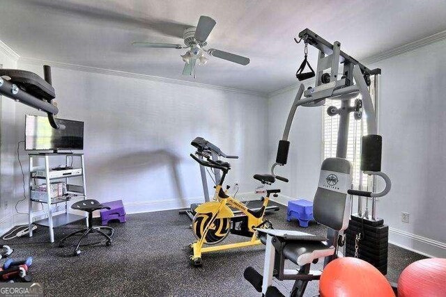 workout area with a ceiling fan, baseboards, and ornamental molding