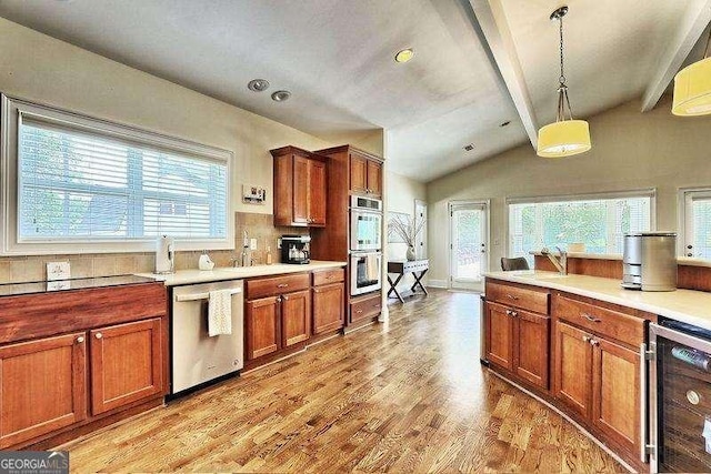 kitchen featuring stainless steel appliances, wine cooler, hanging light fixtures, lofted ceiling with beams, and light hardwood / wood-style flooring